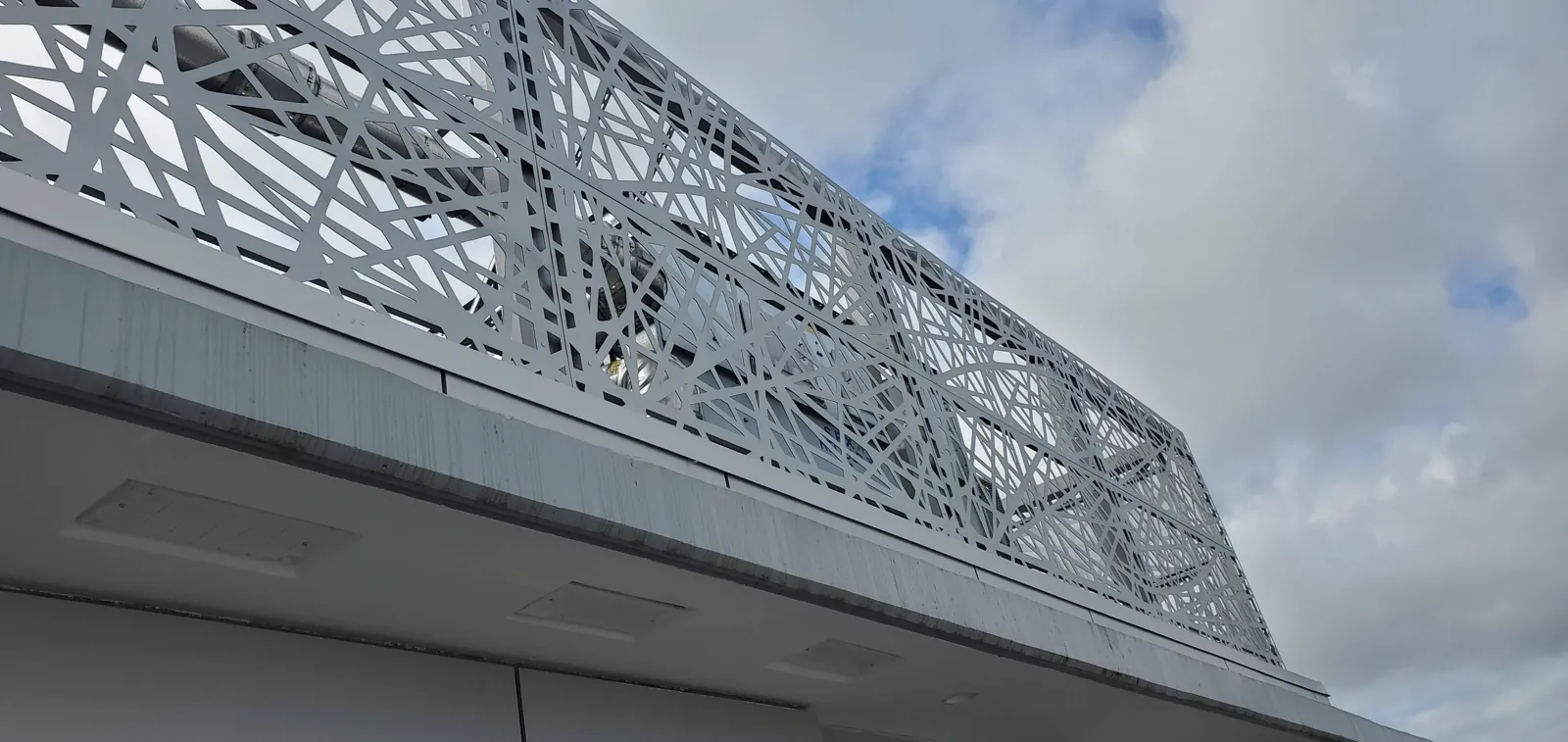 Laser-cut decorative metal facade screen on a building
