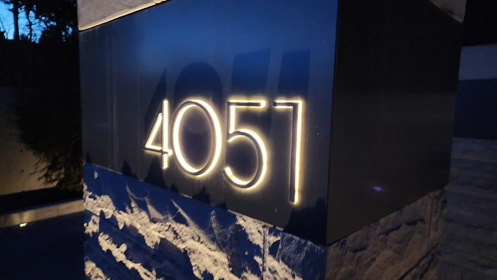 Backlit custom metal address numbers at night