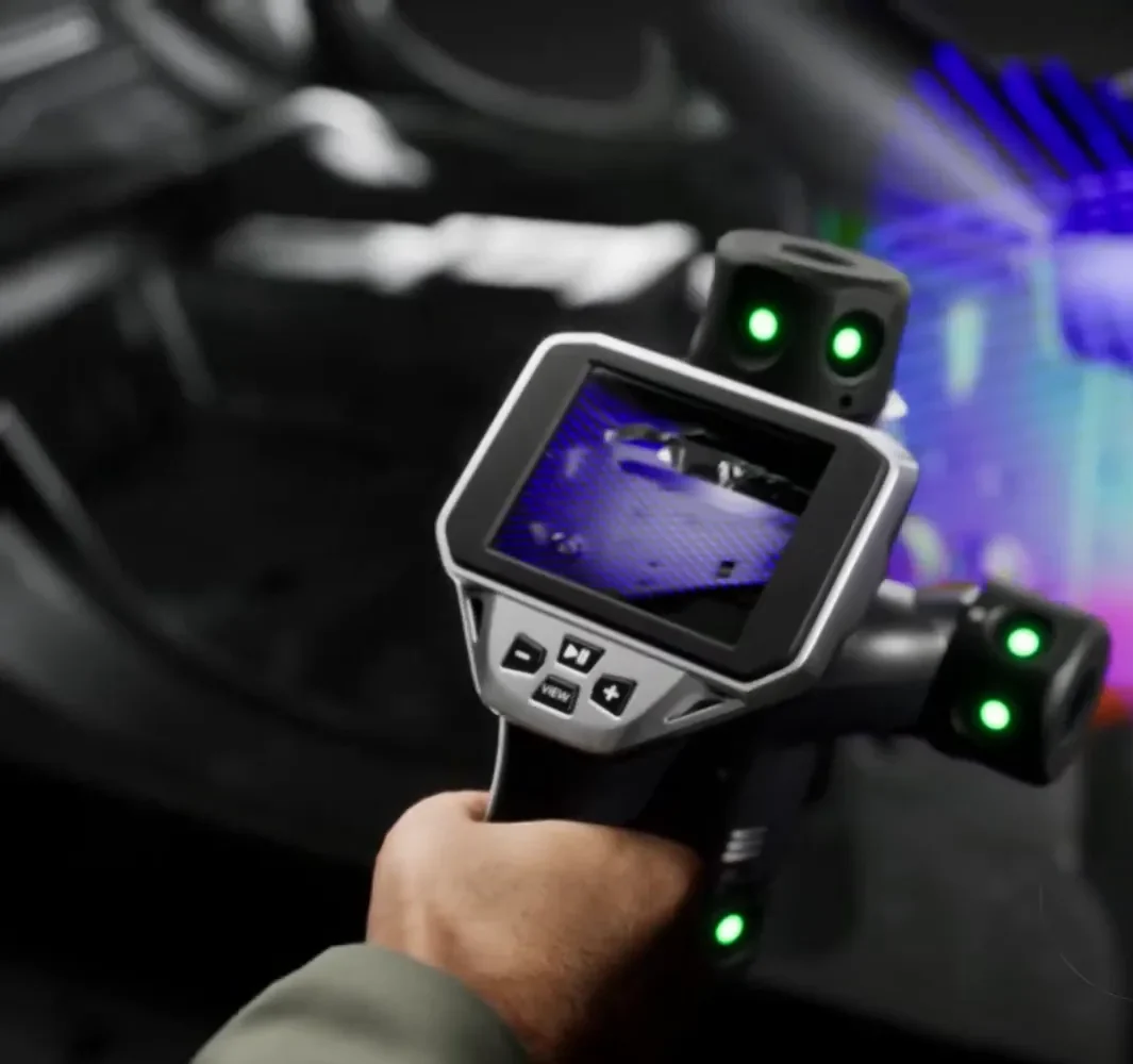 Hand-held laser-scanning probe of the KEYENCE WM-6000 scanning a part, the scan building on its touch screen