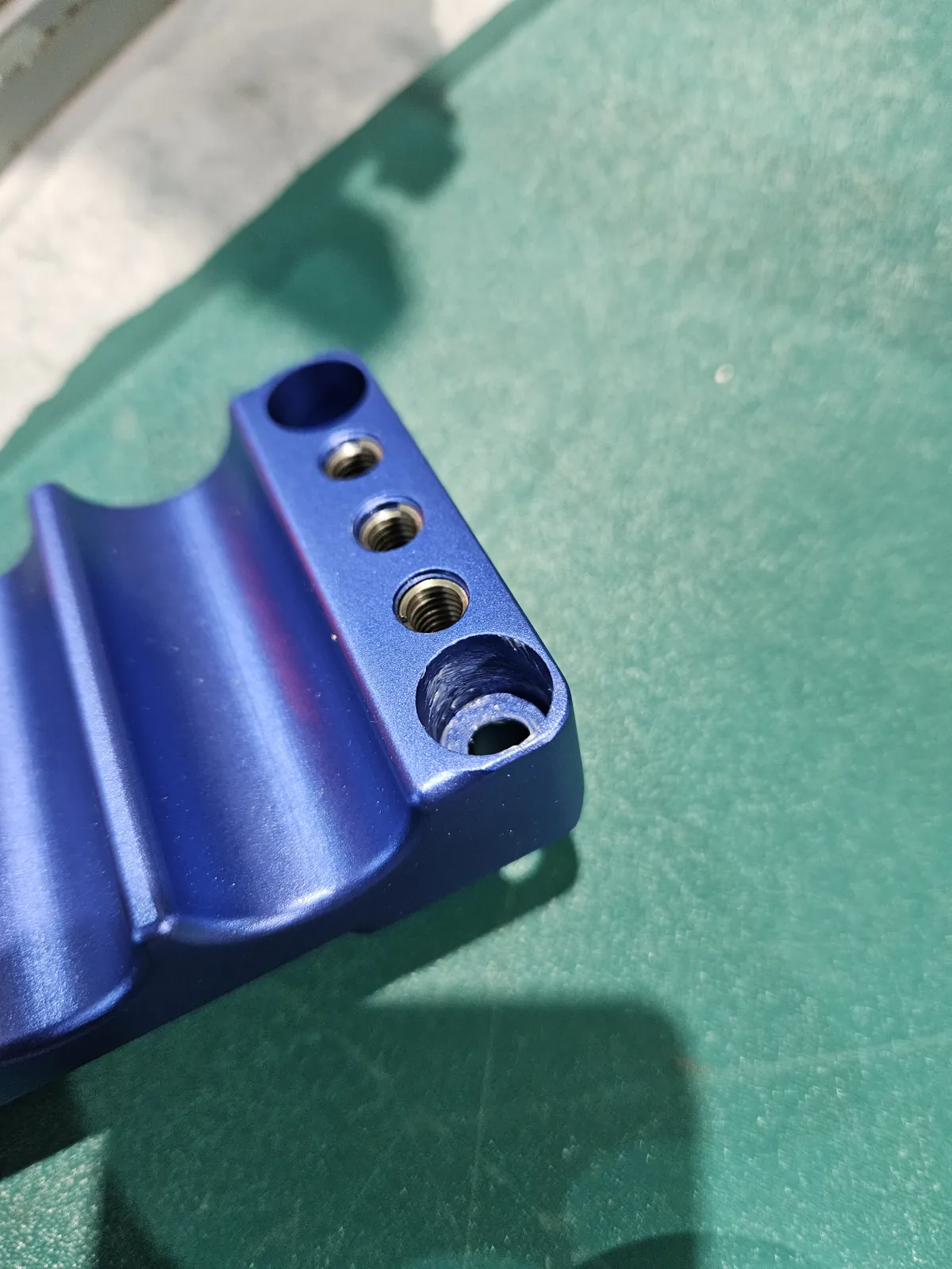 Blue anodized machined aluminum fixture plate