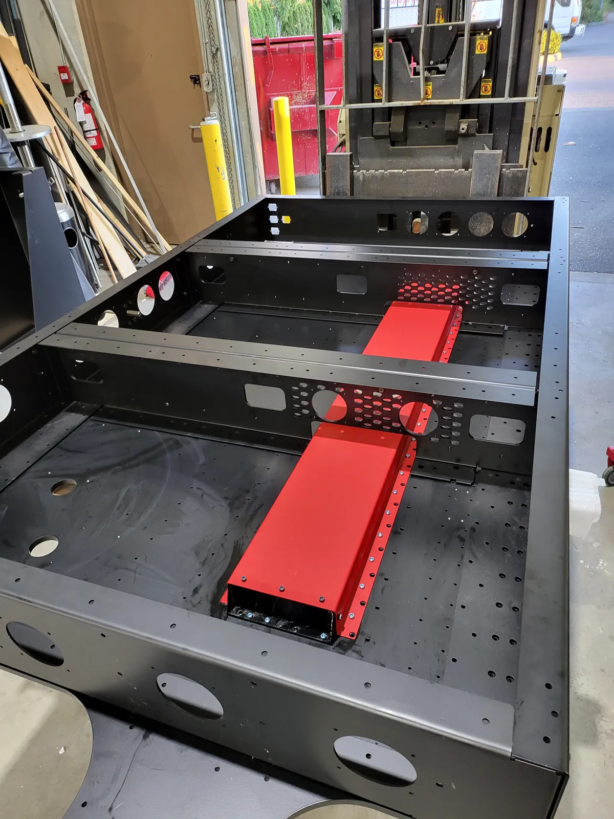 Red fabricated rack mounted on a perforated panel
