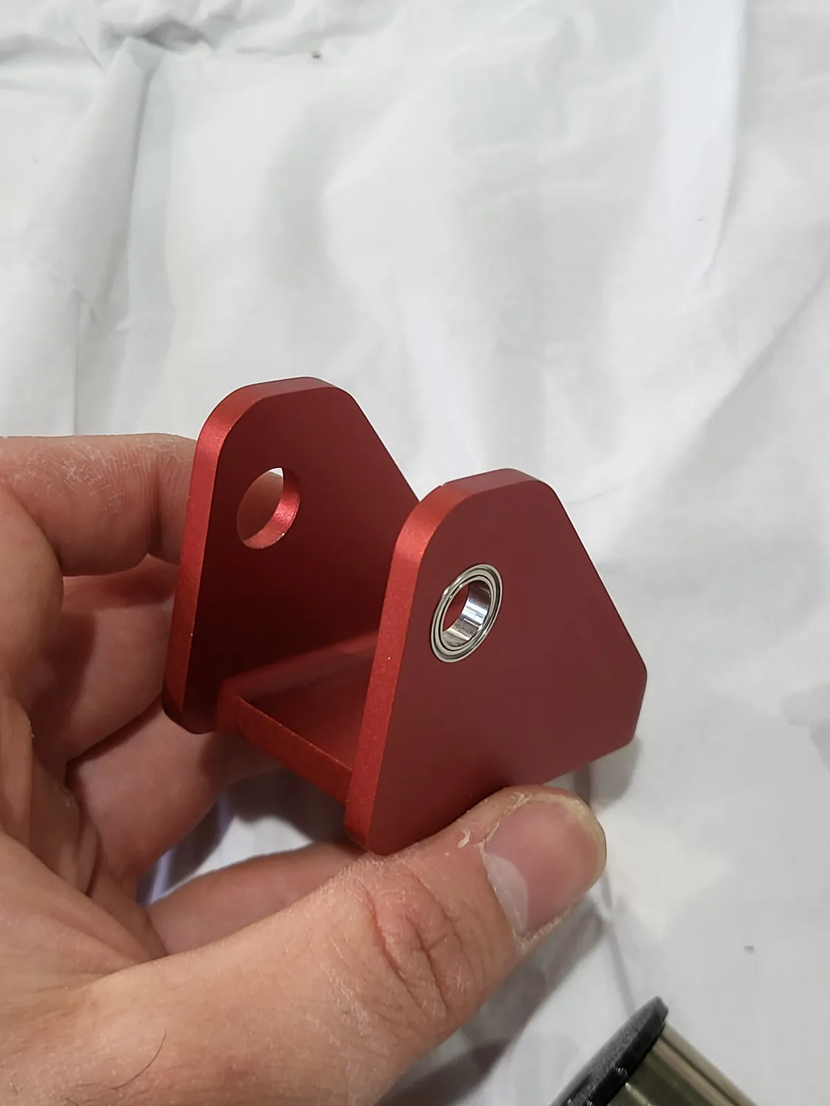 Red anodized machined aluminum bracket
