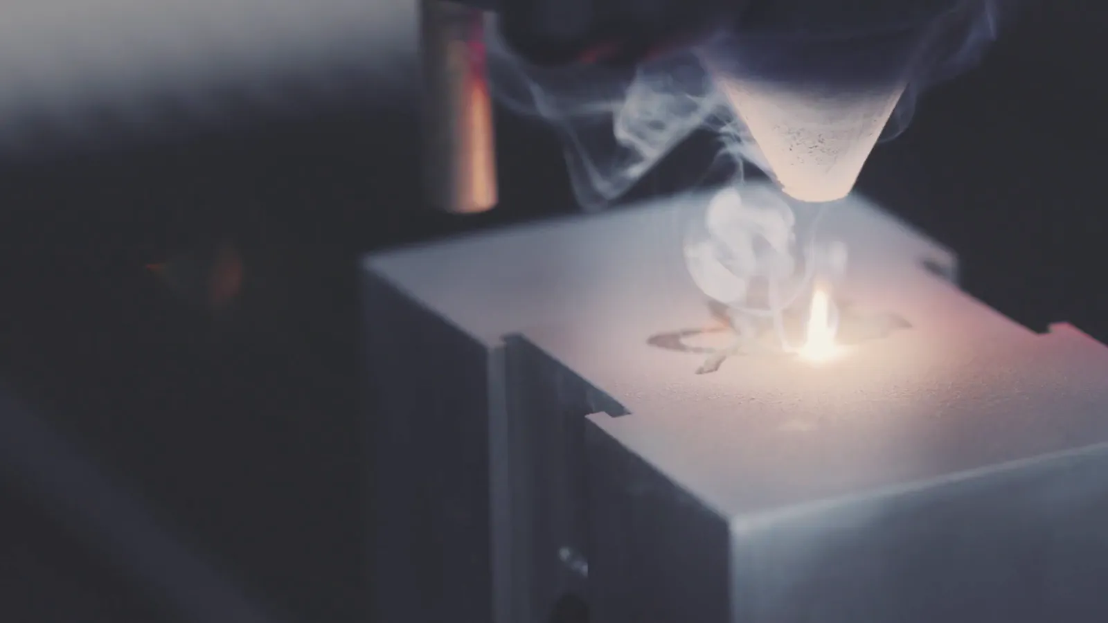 Laser engraving with smoke rising from the beam