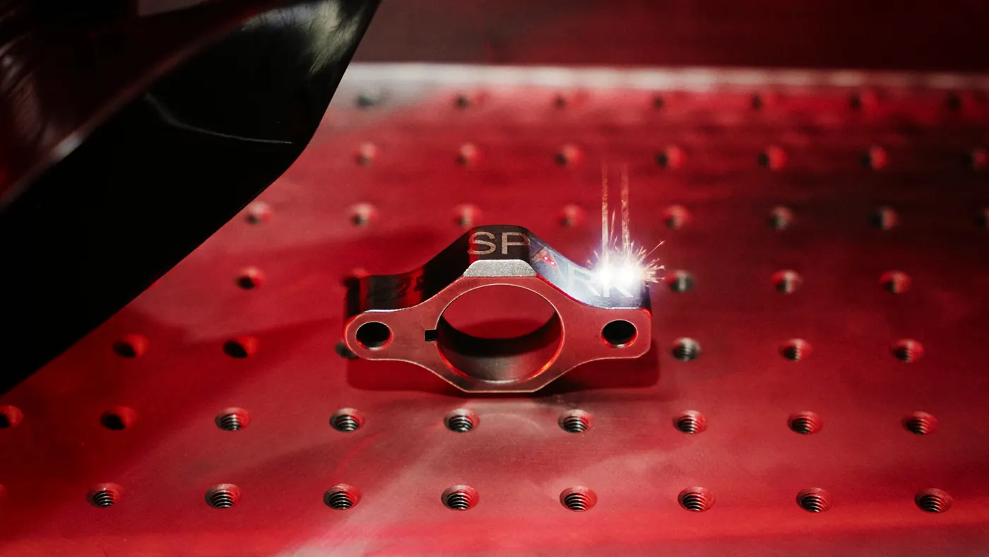 Fiber laser marking a logo on a machined part