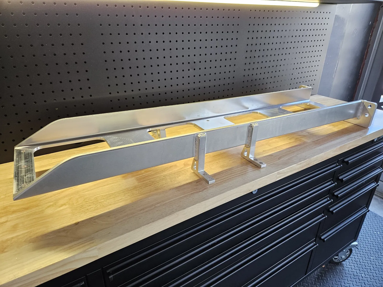 Fabricated and machined aluminum frame on a workbench