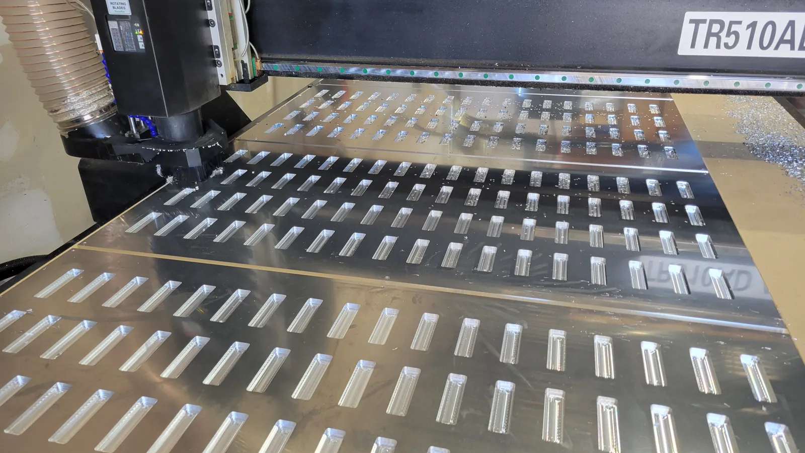 Perforated sheet metal panel being cut on the router