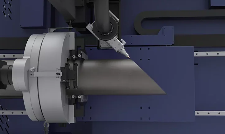 Fiber tube laser head bevel-cutting a steel pipe held in the chuck